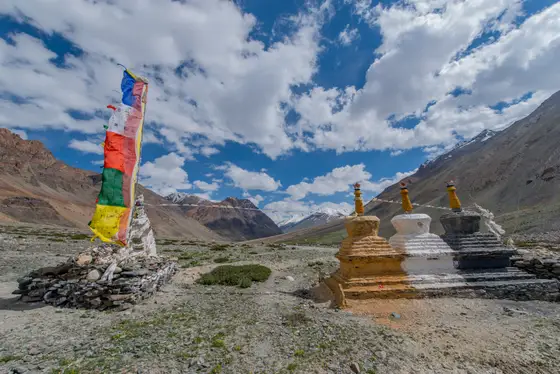 Prayer flag rising over a high mountain pass in Ladakh