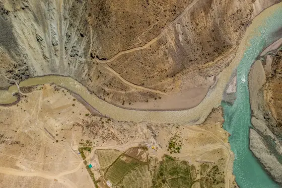 Aerial view of two rivers meeting in a stark Ladakh landscape